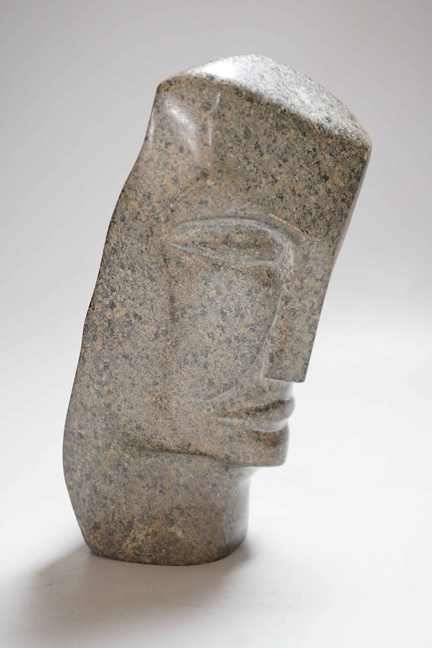 A carved stone head, 23cms high